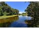 Calm lake view with lush greenery, showcasing a serene natural environment at 5032 Timber Chase Way, Sarasota, FL 34238