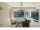 Screened in lanai includes table and chairs with a clear view of a swimming pool at 5032 Timber Chase Way, Sarasota, FL 34238
