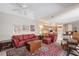 Bright living room showcasing seating, ceiling fans, artwork, and seamless access to the kitchen at 5032 Timber Chase Way, Sarasota, FL 34238