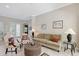 A bright and cozy living room offers a relaxing space with views to the exterior and plenty of natural light at 5032 Timber Chase Way, Sarasota, FL 34238