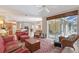 Spacious living room with view to kitchen, dining area, and lanai through sliding glass doors at 5032 Timber Chase Way, Sarasota, FL 34238