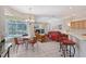 Open-concept living room with rattan chairs, tile floor, view to the pool and bar stool seating at 5032 Timber Chase Way, Sarasota, FL 34238