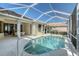 Screened pool with a bright blue water and patio furniture and sliding glass doors to indoors at 5032 Timber Chase Way, Sarasota, FL 34238