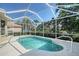 Sparkling pool with screened enclosure and an elegant handrail, surrounded by lush landscaping at 5032 Timber Chase Way, Sarasota, FL 34238