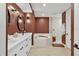 Bright bathroom featuring double vanity, modern fixtures, soaking tub, and glass enclosed shower at 5238 Manorwood Dr # 3C, Sarasota, FL 34235