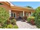 Inviting clubhouse exterior with manicured landscaping and covered entrance at 5238 Manorwood Dr # 3C, Sarasota, FL 34235