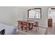 Dining room with modern light fixture, stylish chairs and unique wood table, and views into kitchen at 5238 Manorwood Dr # 3C, Sarasota, FL 34235
