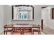 Dining room with modern lighting, wood table and chairs, and views through archway to kitchen at 5238 Manorwood Dr # 3C, Sarasota, FL 34235