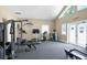 Bright gym with multiple workout stations and equipment; windows and door provide ample natural light at 5238 Manorwood Dr # 3C, Sarasota, FL 34235