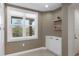 Hallway with storage cabinet, shelving, neutral paint, and a window with treetop views at 5238 Manorwood Dr # 3C, Sarasota, FL 34235