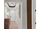 Inviting hallway with ample lighting, neutral tones, and tile flooring, leading to a unit's front door at 5238 Manorwood Dr # 3C, Sarasota, FL 34235