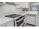Close up of kitchen featuring white cabinets, sleek appliances, and modern design at 5238 Manorwood Dr # 3C, Sarasota, FL 34235