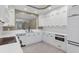 Contemporary kitchen featuring white cabinets, sleek appliances, and modern design at 5238 Manorwood Dr # 3C, Sarasota, FL 34235