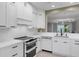 Stylish kitchen with white cabinetry, state-of-the-art appliances, and a modern aesthetic at 5238 Manorwood Dr # 3C, Sarasota, FL 34235