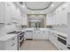 Well-lit kitchen with white cabinets, modern appliances, and ample countertop space at 5238 Manorwood Dr # 3C, Sarasota, FL 34235
