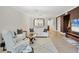 Spacious living room featuring white sofas, natural wood accents, and lots of natural light at 5238 Manorwood Dr # 3C, Sarasota, FL 34235