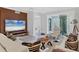 Well-lit living room with a modern aesthetic, featuring comfortable seating and an open view of the outdoor area at 5238 Manorwood Dr # 3C, Sarasota, FL 34235
