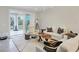 Spacious living room with stylish decor and ample natural light, enhanced by an adjacent outdoor balcony at 5238 Manorwood Dr # 3C, Sarasota, FL 34235