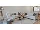 Bright living room with plush white sofas, unique coffee table, and stylish decor at 5238 Manorwood Dr # 3C, Sarasota, FL 34235