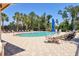 Community pool with lounge seating and mature landscaping at 5238 Manorwood Dr # 3C, Sarasota, FL 34235