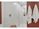 Bright glass enclosed shower with tile surround and modern showerhead at 5238 Manorwood Dr # 3C, Sarasota, FL 34235