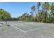 Outdoor tennis court surrounded by mature landscaping at 5238 Manorwood Dr # 3C, Sarasota, FL 34235