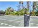 Close up view of the outdoor tennis court showing the net and green playing surface at 5238 Manorwood Dr # 3C, Sarasota, FL 34235