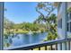 Balcony view of a serene lake with a fountain and lush green trees at 5238 Manorwood Dr # 3C, Sarasota, FL 34235