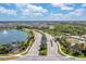 Aerial view of the community, lake, and surrounding landscape at 5715 Woodland Sage Dr, Sarasota, FL 34238