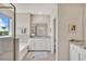 Bright bathroom featuring dual vanities with granite countertops and tile flooring at 5715 Woodland Sage Dr, Sarasota, FL 34238