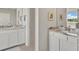 Bright bathroom featuring dual vanities with granite countertops and tiled floors at 5715 Woodland Sage Dr, Sarasota, FL 34238