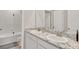 Modern bathroom with dual sinks, granite counters, and white cabinets at 5715 Woodland Sage Dr, Sarasota, FL 34238