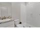 Bright bathroom featuring a vanity with a granite countertop and a glass-enclosed shower at 5715 Woodland Sage Dr, Sarasota, FL 34238