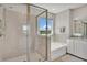 Luxurious primary bathroom featuring a separate glass enclosed shower and soaking tub with views at 5715 Woodland Sage Dr, Sarasota, FL 34238