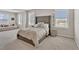 Bright bedroom featuring large windows with plantation shutters, plush carpeting, and sitting area at 5715 Woodland Sage Dr, Sarasota, FL 34238