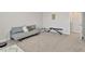 View of a bedroom featuring a gray sofa, carpet, and a work out bench at 5715 Woodland Sage Dr, Sarasota, FL 34238