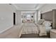 Spacious primary bedroom featuring tray ceilings and a large sitting area with plentiful natural light at 5715 Woodland Sage Dr, Sarasota, FL 34238