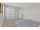 Bright, carpeted secondary bedroom featuring plantation shutters and neutral paint at 5715 Woodland Sage Dr, Sarasota, FL 34238