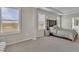 Bright bedroom featuring large windows with plantation shutters and an en suite bathroom at 5715 Woodland Sage Dr, Sarasota, FL 34238