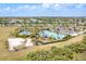 Aerial view of the community pool with beach volleyball court, playground, and covered seating area at 5715 Woodland Sage Dr, Sarasota, FL 34238