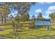 Community sign for Sarasota County Scherer Thaxton Preserve with wood fence and lush green landscaping at 5715 Woodland Sage Dr, Sarasota, FL 34238