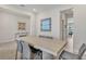 Open dining area with stylish table, chairs, and contemporary artwork creating an inviting atmosphere at 5715 Woodland Sage Dr, Sarasota, FL 34238