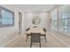Bright dining room featuring large windows, shutters, and a modern light fixture at 5715 Woodland Sage Dr, Sarasota, FL 34238