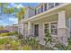 Inviting front porch with stone-wrapped columns and manicured landscaping at 5715 Woodland Sage Dr, Sarasota, FL 34238