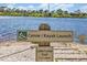 Canoe/Kayak launch sign with Lake Loop Trail marker indicating a 1.17-mile trail at 5715 Woodland Sage Dr, Sarasota, FL 34238