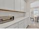 Kitchen area featuring a counter with white cabinets, and granite countertop at 5715 Woodland Sage Dr, Sarasota, FL 34238