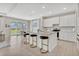 Open kitchen with a breakfast bar, marble countertops, and view of the backyard at 5715 Woodland Sage Dr, Sarasota, FL 34238