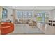 Bright living room with tile floors, large windows, and modern furnishings at 5715 Woodland Sage Dr, Sarasota, FL 34238