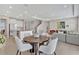 Open-concept living and dining area featuring tile floors and recessed lighting at 5715 Woodland Sage Dr, Sarasota, FL 34238