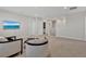 Upstairs bonus room with a TV, seating area, and neutral decor, perfect for entertaining at 5715 Woodland Sage Dr, Sarasota, FL 34238